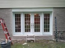 newly installed glass patio doors with an extra panel on each side