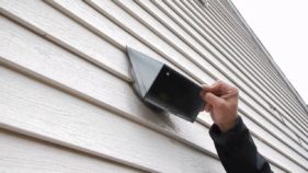 vent install with white wood grain siding