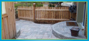 wooden fence and interlocking stone walkway with steps