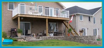 interlocking retaining wall surrounding deck at back of house