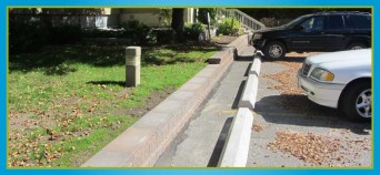 retaining wall separating lawn from parking lot