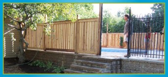 wooden and wrought iron fencing surrounding pool