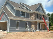 house with blue siding mixed with stone