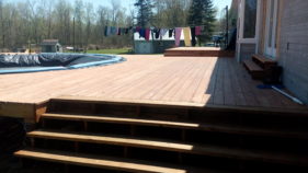 newly constructed wooden deck surrounding pool